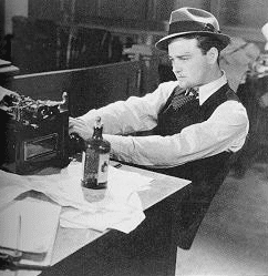 Picture of 1950s editor looking at press releases